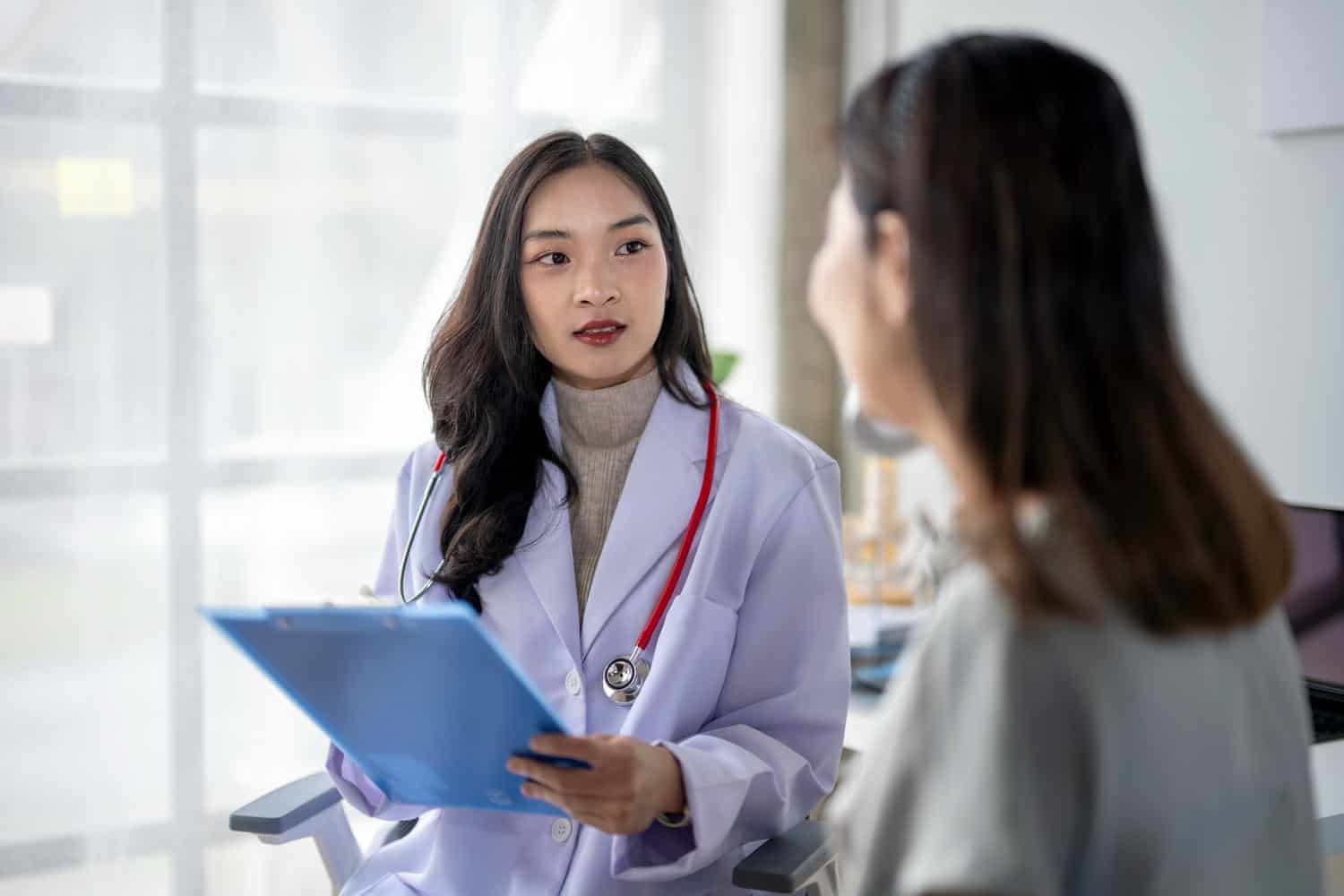 Healthcare professional discussing patient care in an allied health setting.